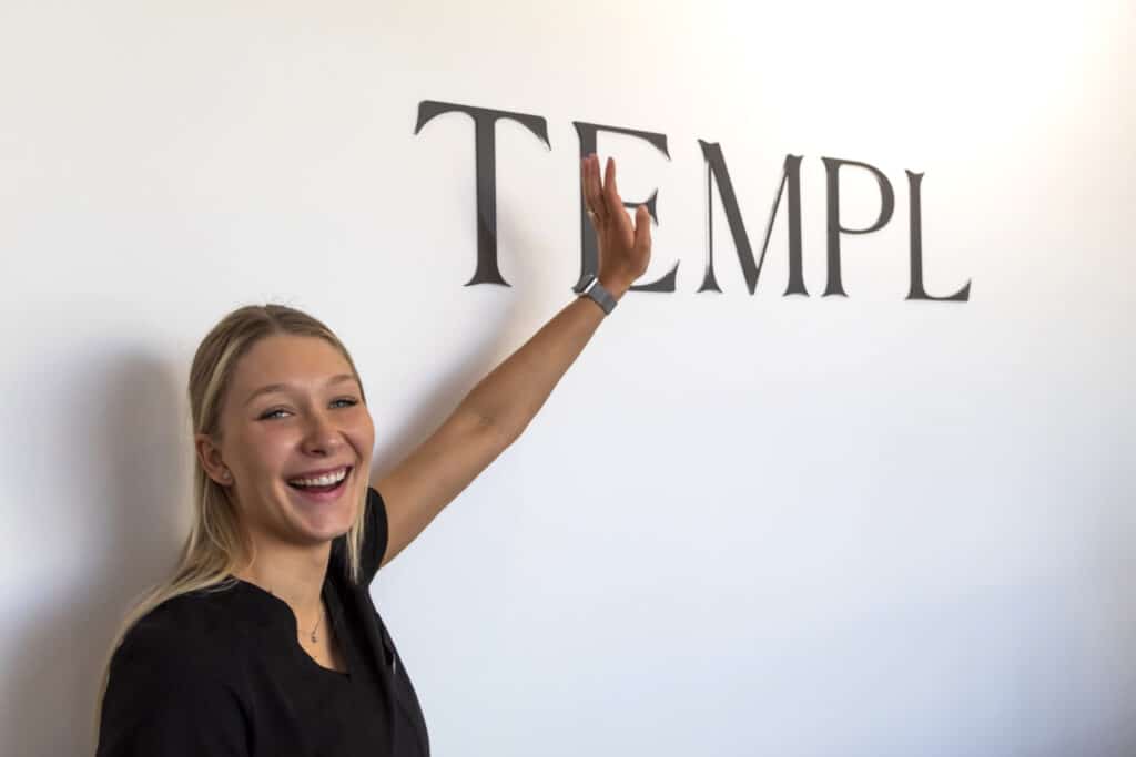 Genevieve posing in front of the TEMPL sign